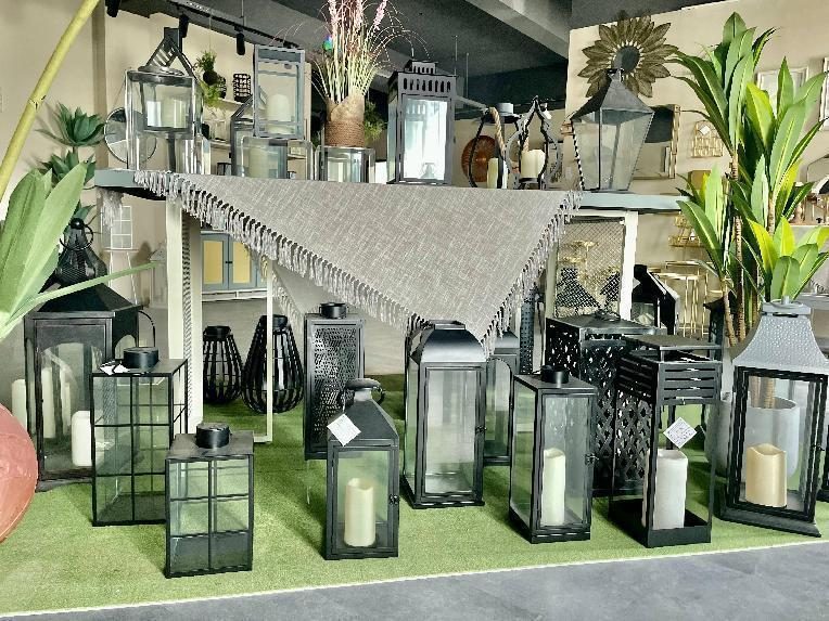 Rows of black metal and glass lanterns in graduated sizes on a display platform