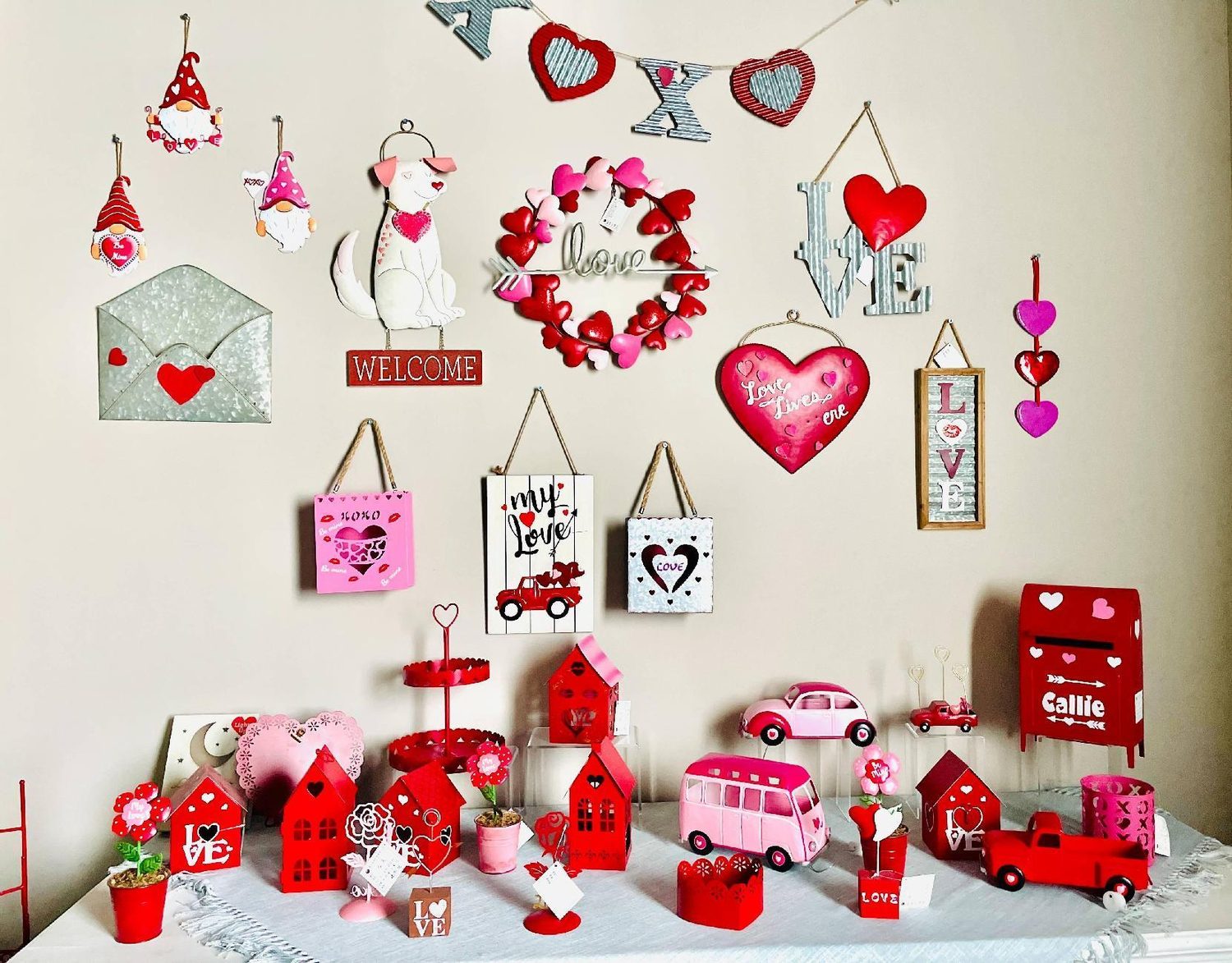 A Valentine display of hanging hearts, mail-box pieces and pink trucks